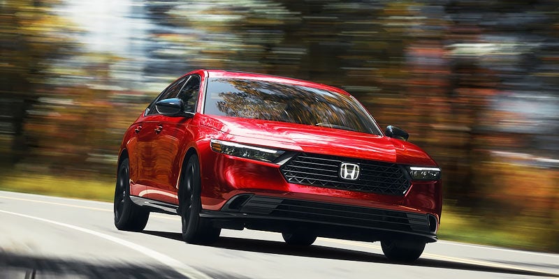 new red Honda accord driving on road