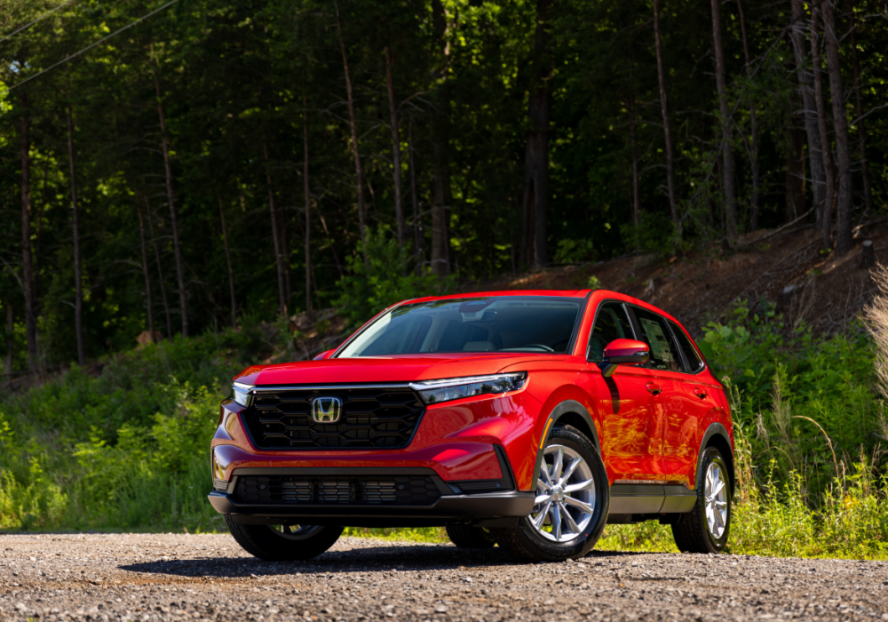 Stock photo of a red 2025 Nissan Rogue showing the front exterior of the car