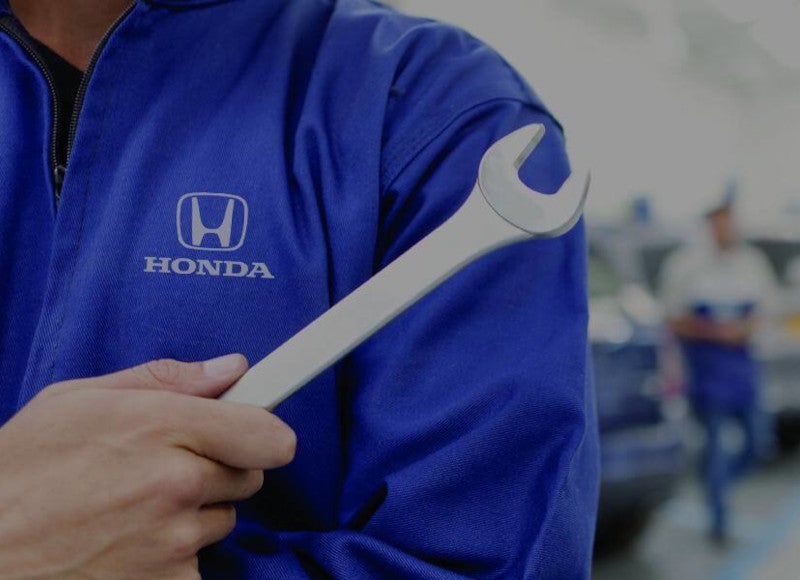 Honda technician holding wrench