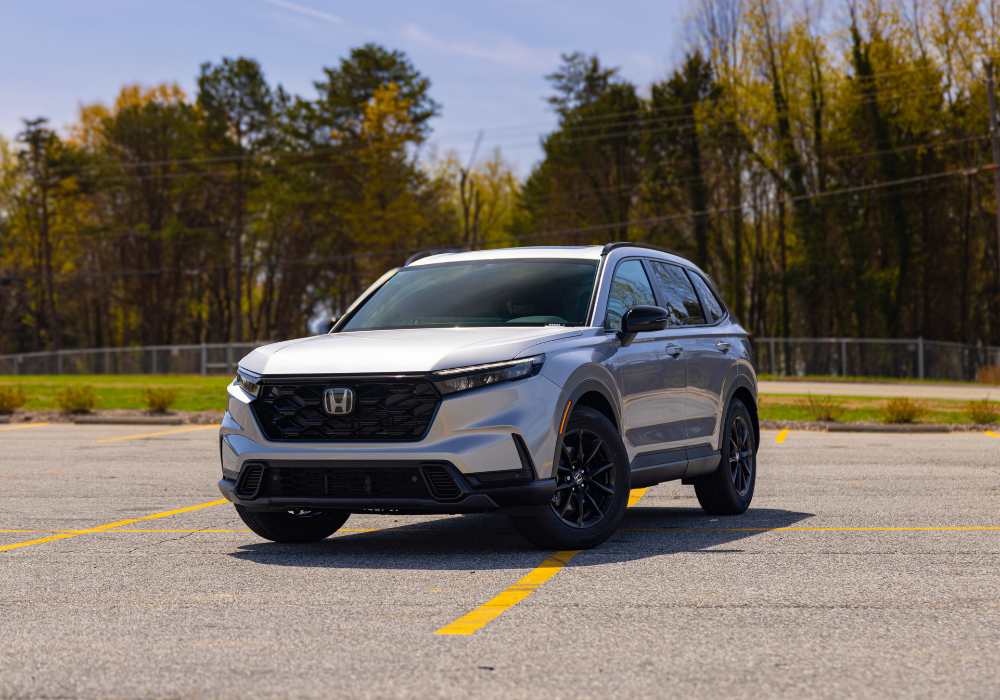 2026 Honda CR-V Hybrid Sport-L. The SUV is white and parked on a paved surface. 